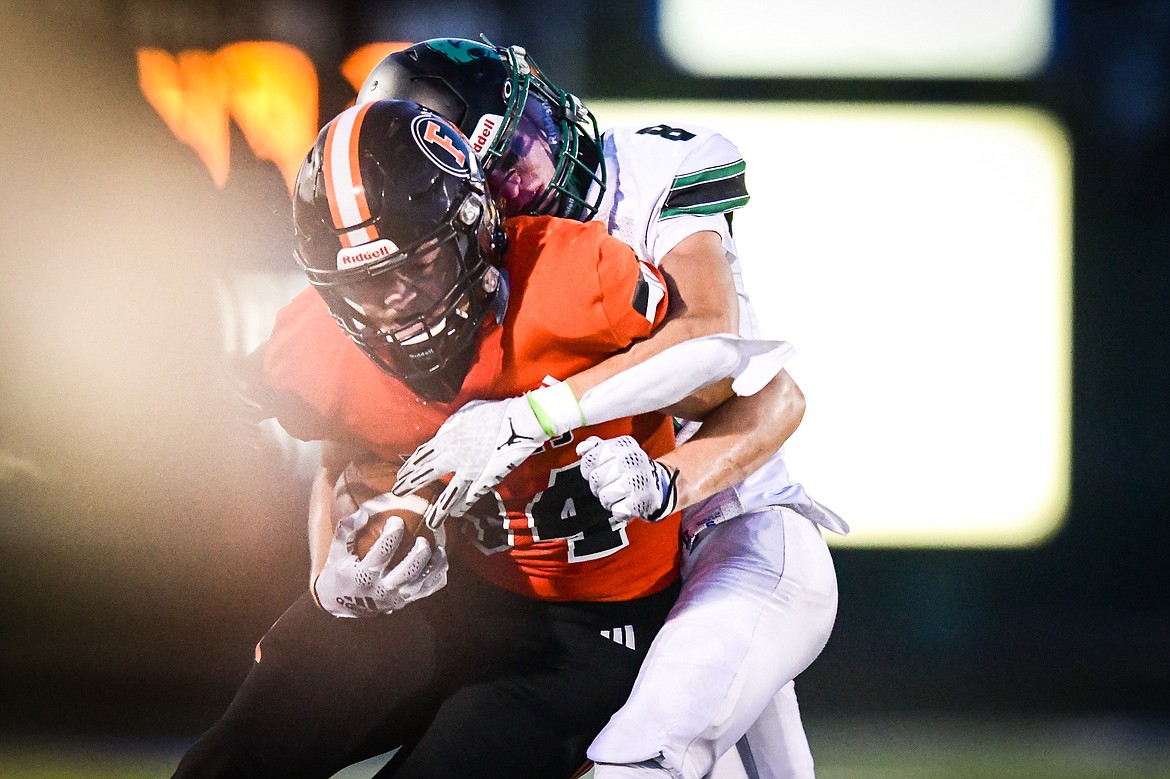 Flathead tight end Gabe Sims (84) is tackled after a reception in the third quarter against Belgrade at Legends Stadium on Friday, Sept. 1. (Casey Kreider/Daily Inter Lake)