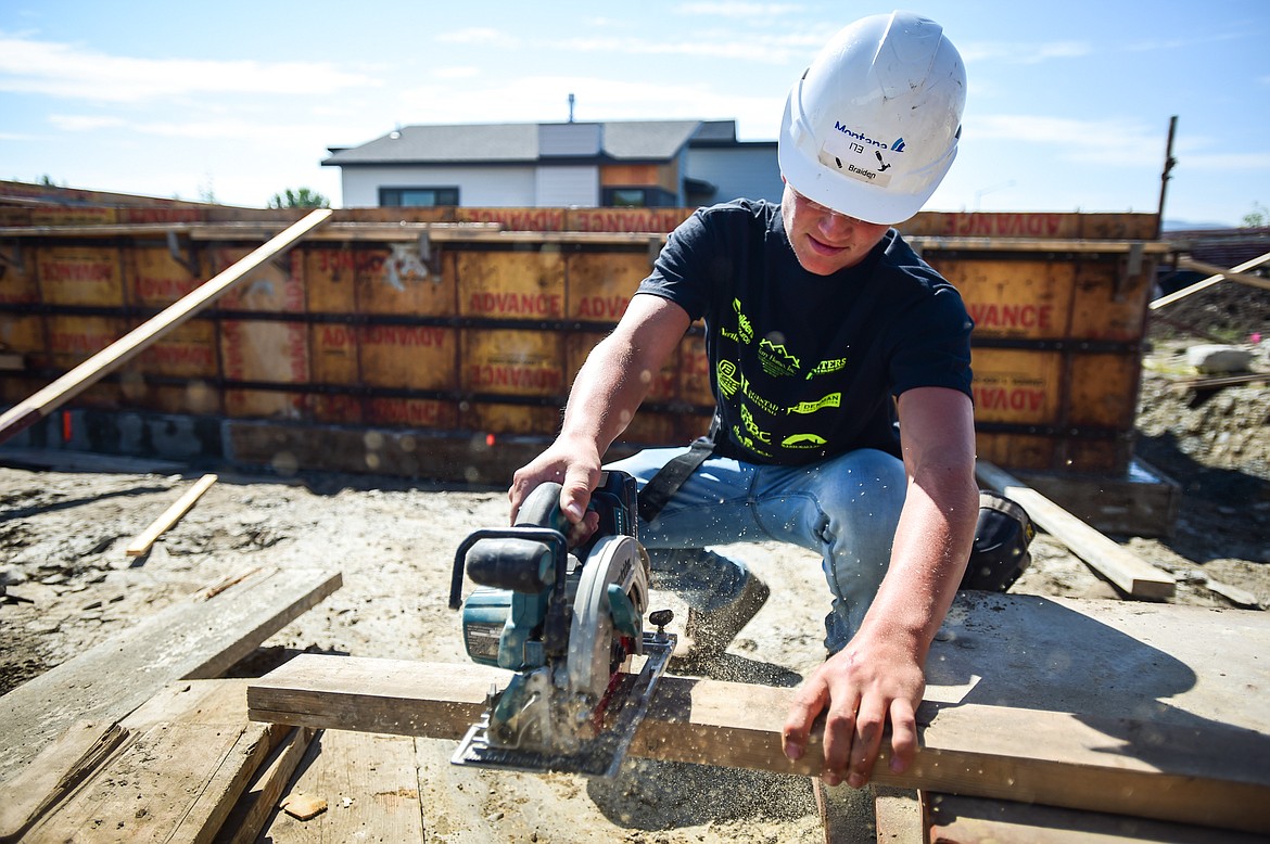 Flathead High School senior Eli Simonsen practices measuring and using a circular saw at a Kalispell Student Built Homes site on Northridge Way on Friday, Sept. 1. (Casey Kreider/Daily Inter Lake)