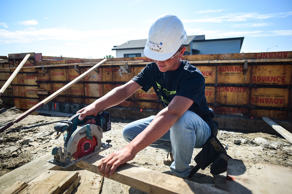 Flathead High School senior Eli Simonsen practices measuring and using a circular saw at a Kalispell Student Built Homes site on Northridge Way on Friday, Sept. 1. (Casey Kreider/Daily Inter Lake)