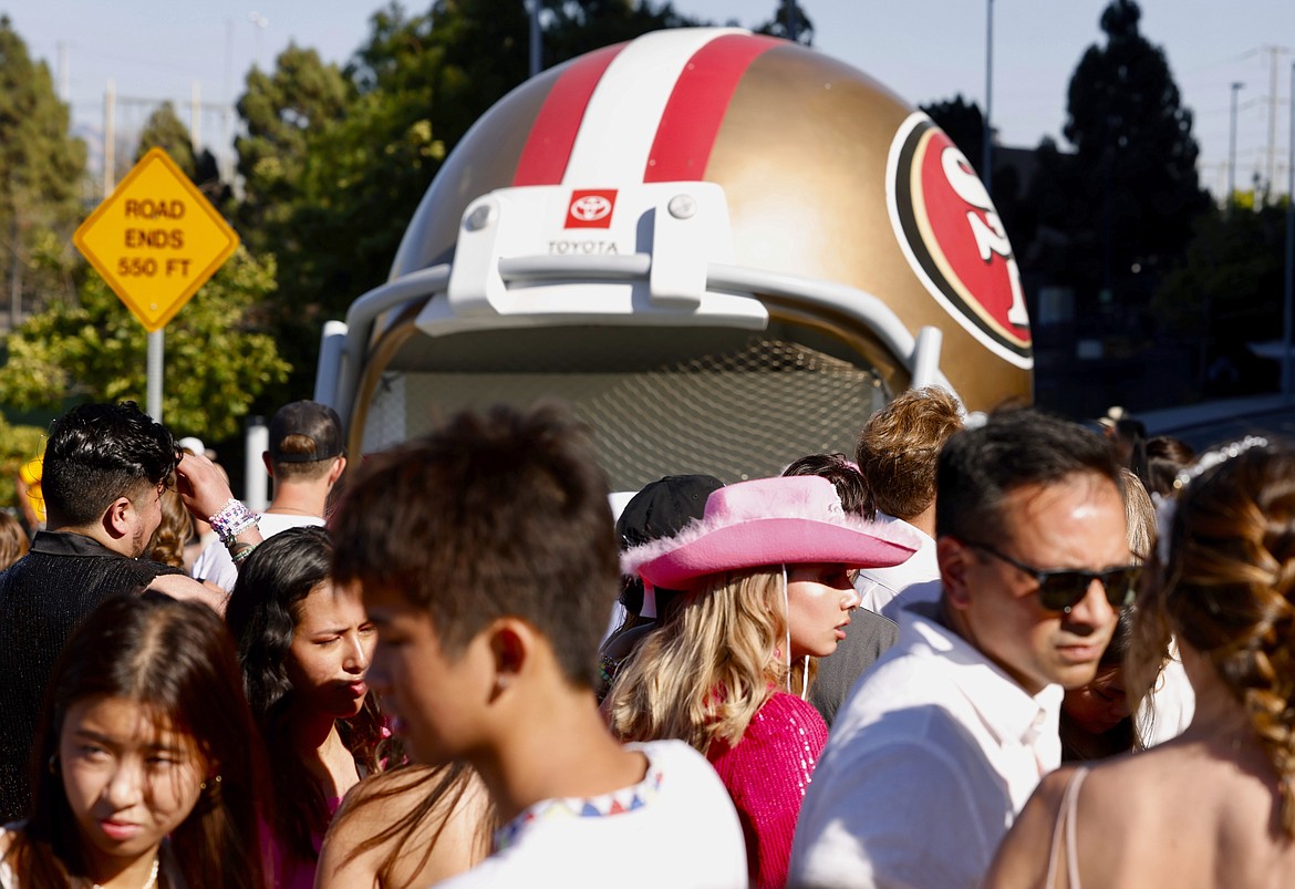 FILE - Fans wait to go through security before Taylor Swift performs at Levi's Stadium in Santa Clara, Calif., Friday, July 28, 2023. Fan frustration over getting tickets to Swift's tour prompted Congressional hearings and multiple bills in state legislatures. Consumer advocates in California say they are disappointed legislation in California has been watered down to solely banning hidden fees, a practice most major industry players have already committed to do. (Jessica Christian/San Francisco Chronicle via AP, File)/San Francisco Chronicle via AP)