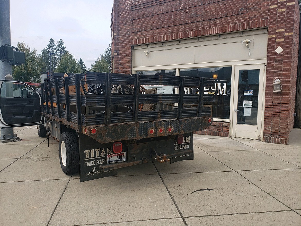 A truck with mold-tainted items is seen Thursday in front of the Post Falls Museum, where crews are working to mitigate a mold outbreak in the basement. If all goes well, the museum, which has been closed all season, could open to the public later this month.