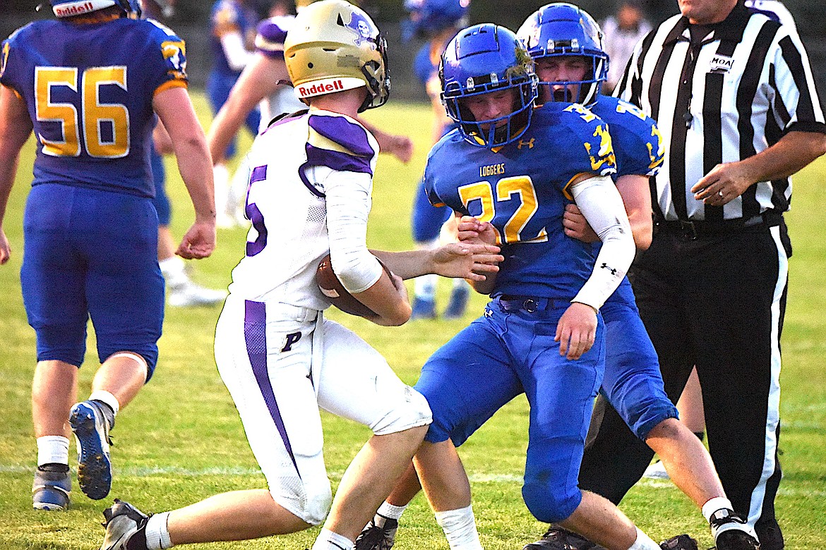 Libby's Connor Benson (34) celebrates with teammate Trent Riddel (21) after sacking Polson quarterback Holden Emerson on Sept. 1 at Logger Stadium. (Scott Shindledecker/The Western News)