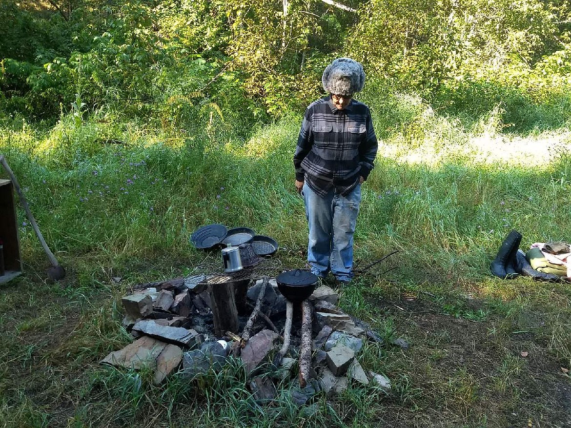 Ginny Tubb was Dutch oven cooking on Cayuse Creek when the Cedar Creek Tour stopped for a history lesson. This location is where the first gold was discovered in the area that forever changed the landscape. This annual tour is sponsored by the Mineral County Museum and Historical Society. (Photo courtesy of Peggy Temple)