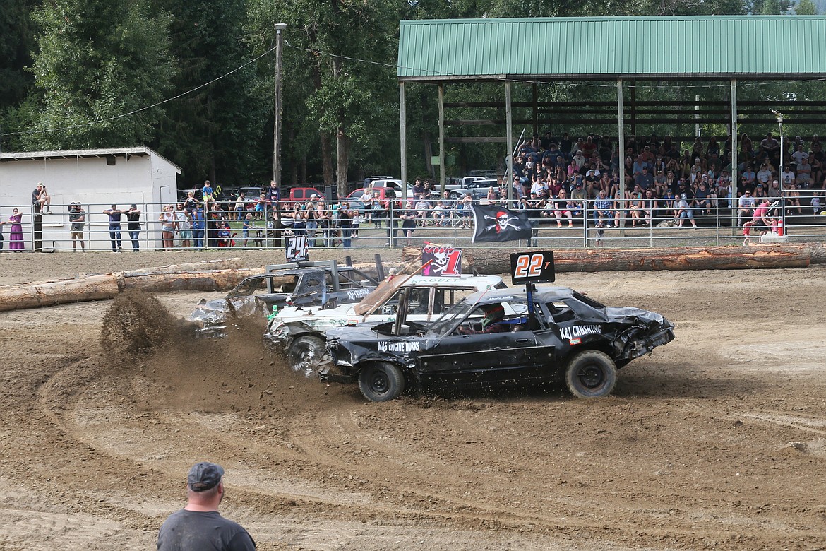 Steve Henry's "Rabbit" is caught between Casey Thorne, No. 24T, and Cory Thorne, No. 22T, Saturday during the Paul Bunyan Days Crash for Cash Demolition Derby at the Benewah County Fairgrounds.