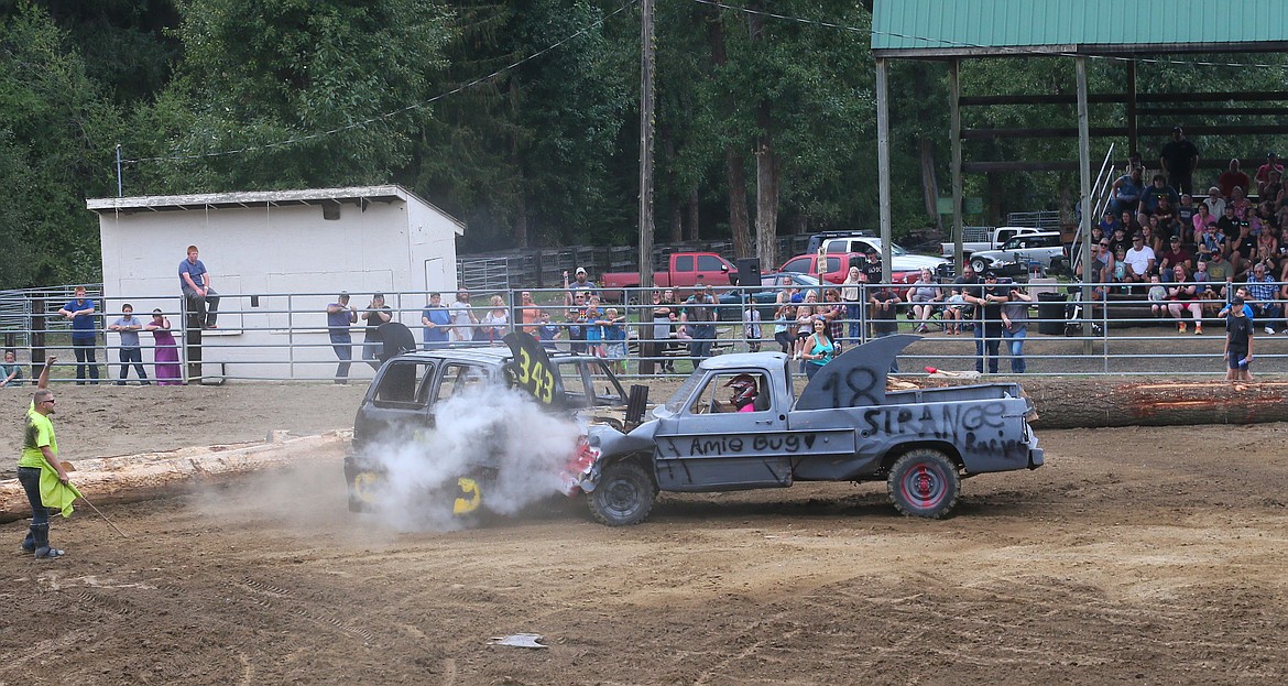 Amie Strange plows "Sharkie" into Spencer Strange's "Batman" Saturday during the Paul Bunyan Days Crash for Cash Demolition Derby in St. Maries.