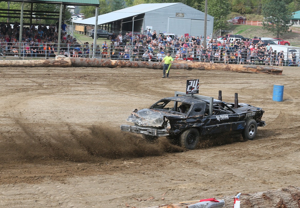 Casey Thorne kicks up dirt as he spins through the arena Saturday during the Crash for Cash Demolition Derby at the Benewah County Fairgrounds in St. Maries.