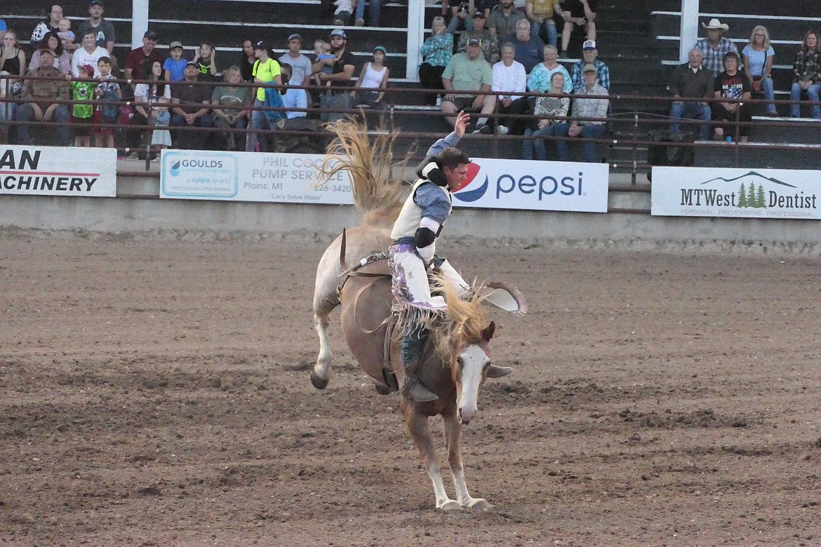 A bareback bronc rider hangs on for the full eight seconds during Thursday's first go-round of the Sanders County Fair Rodeo. (Chuck Bandel/Valley Press)