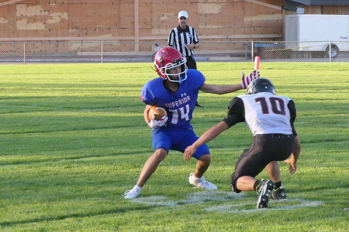 Superior running back/defensive back Trizten Avila tries to avoid being tackled by a Plains defender during their game Friday night in Superior.  (Chuck Bandel/VP-MI)