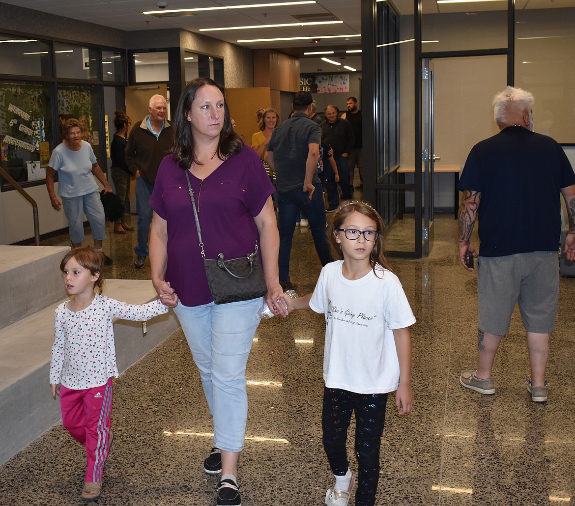 Mandy Brink of Almira looks around the new Almira School with her children Sophie, 4, left, and Lily, 7.