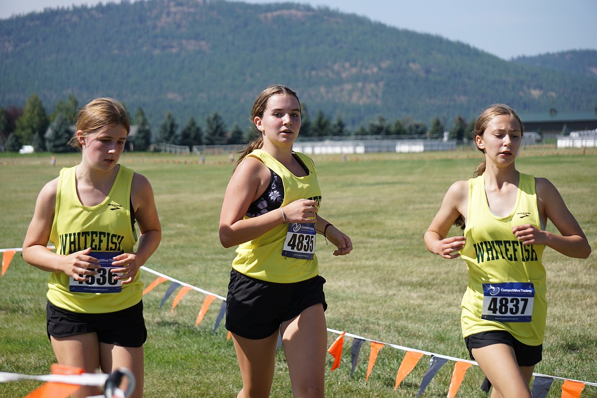 The Whitefish Freshmen trio of Sierra Gibb (left), Sophie Douglas (center) and Grace Inabnit (right) continue to impress, easily taking three of the top five positions at the Flathead Invite ‘Frosh’ race on Friday. (Photo provided)