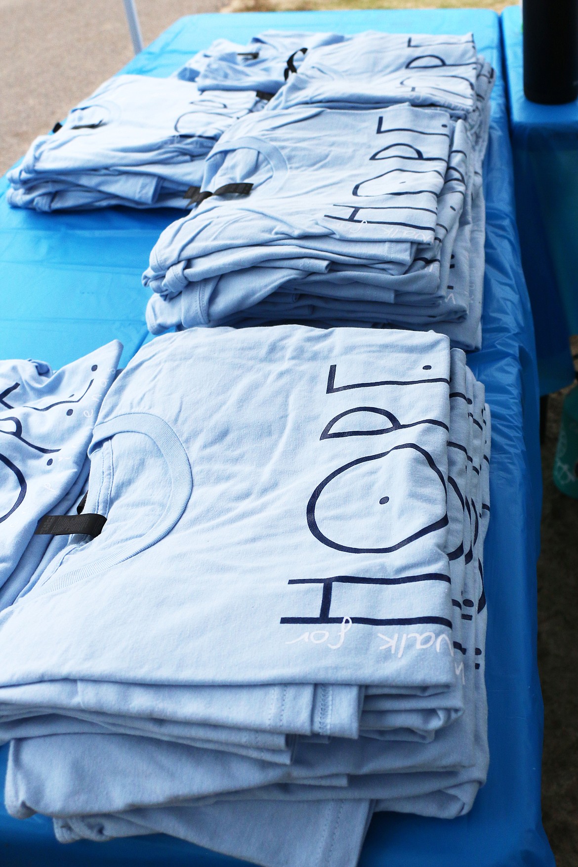 T-shirts line a table at the 2023 Walk for HOPE.