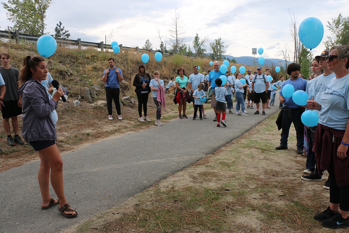 Jennifer Wyman, founder of Hold On Pain Ends, a nonprofit dedicated to suicide awareness, talks to participants in the 2023 Walk for HOPE before they head out on the annual walk.