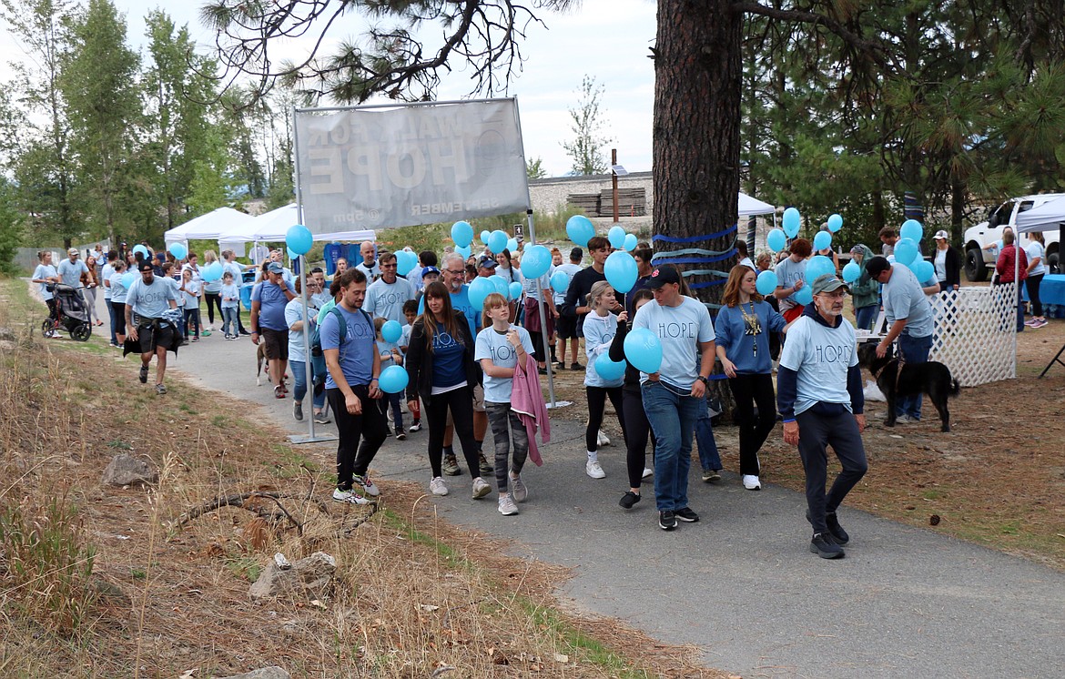 Participants in the 2023 Walk for HOPE head away from Dog Beach and toward the walking bridge across Lake Pend Oreille to call attention to suicide awareness.