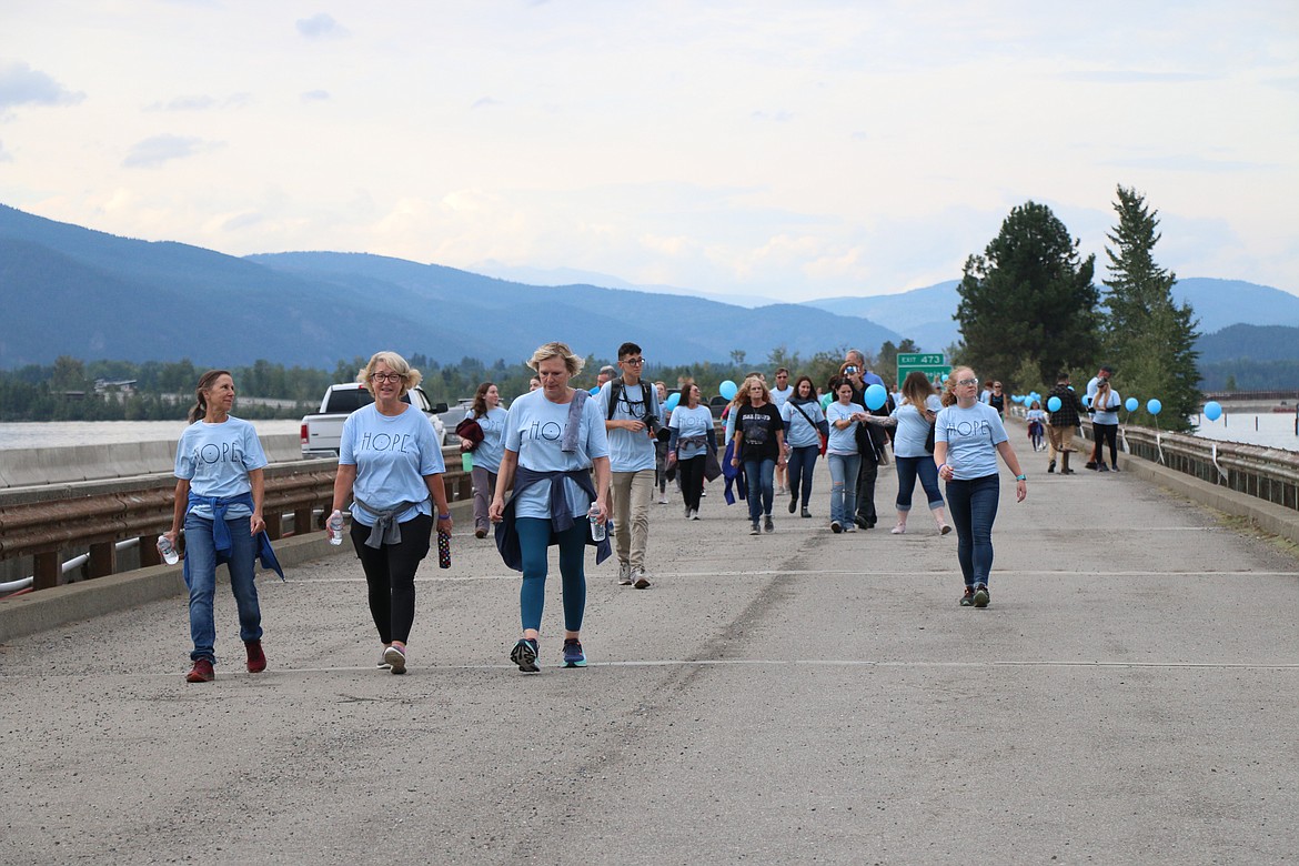 Participants in the 2023 Walk for HOPE walk across the walking bridge as they take part in the annual event, which aims to call attention to suicide awareness.