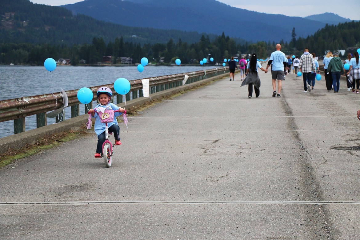 A Walk for HOPE participant has fun as she rides back across the walking bridge during the 2023 event.