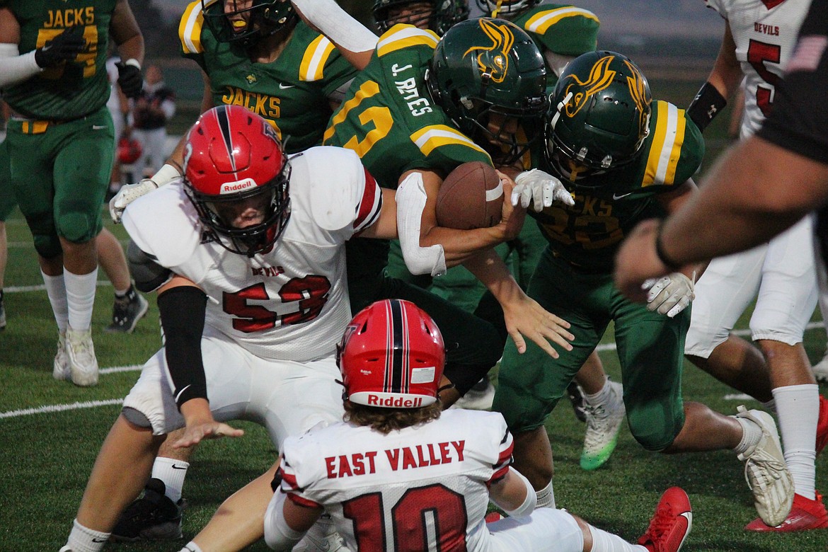 Jace Reyes (13), Quincy, pushes upfield against the East Valley (Yakima) defense. The Red Devils beat the Jacks 42-14.