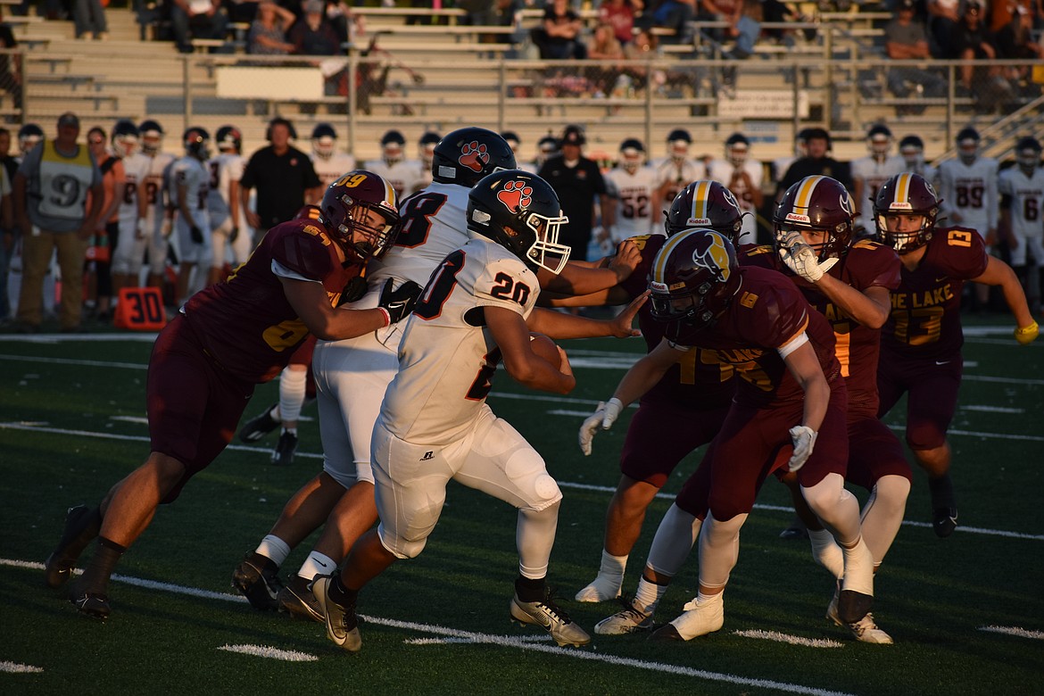 Ephrata junior Elijah Chavez-Mabry (20) bounces outside on a six-yard run against the Moses Lake defense on Friday night.