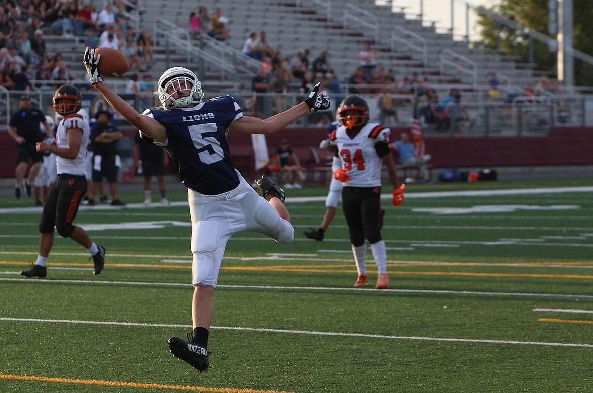 MLCA/CCS sophomore Jonny Ferguson (5) reaches out to catch a one-handed touchdown pass from quarterback Rubin Ulyanchuk in the second quarter against Bridgeport on Saturday.