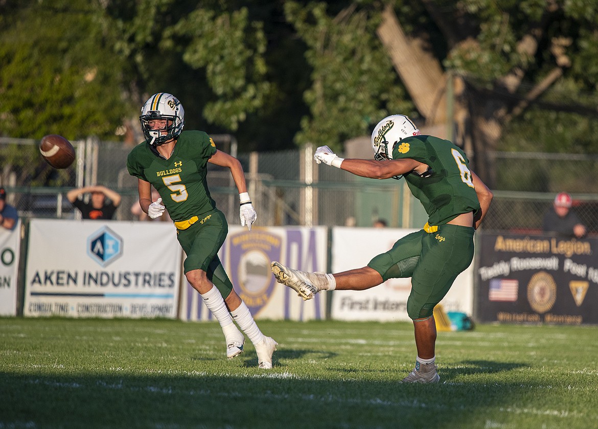 Kicker Ryder Barinowski, right, launches one downfield at the Dog Pound in a game against Lincoln County on Friday, Sept. 1. (Avery Howe/Hungry Horse News)