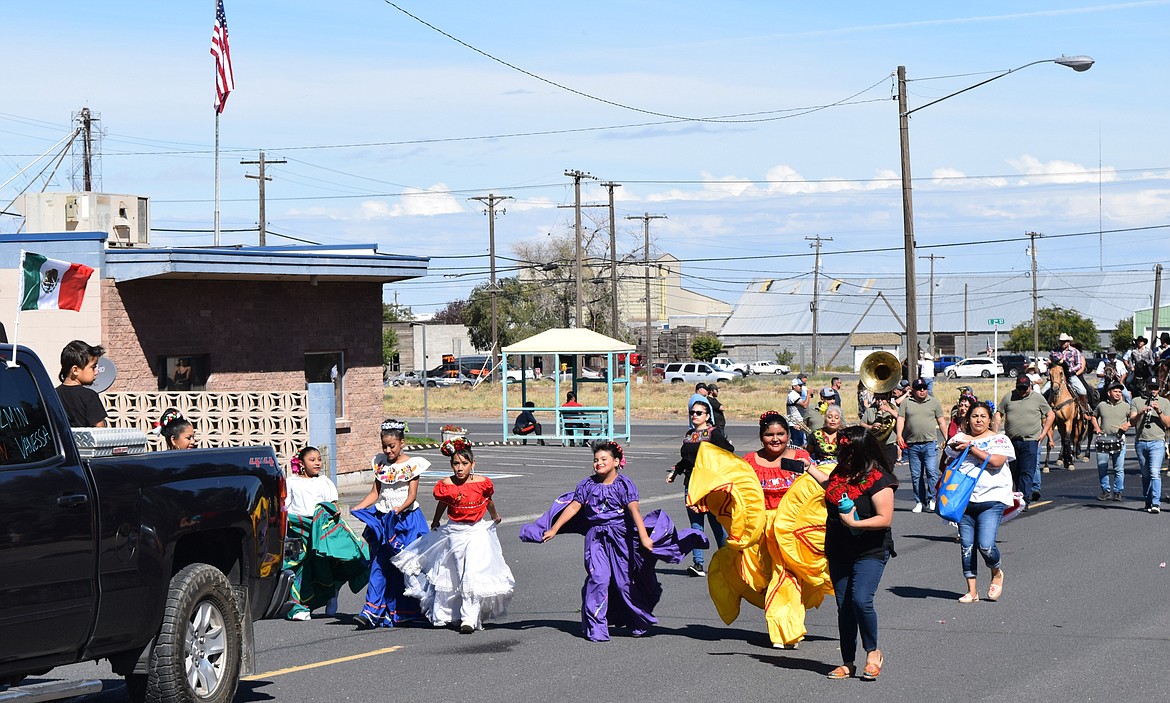 Local residents dance to music during the Warden Community Days parade Monday morning.