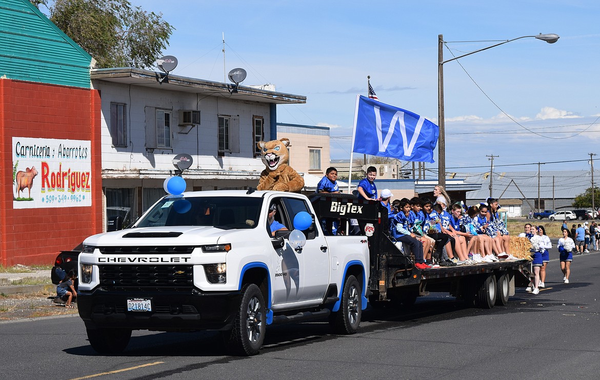 A Warden school athletics float rolls down Ash Street with the school’s cougar mascot on top during the Community Days parade.