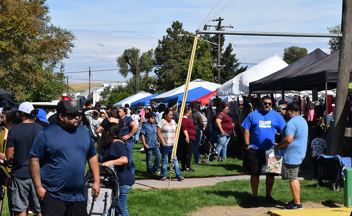 Warden Community Days attendees browse vendors lining the edge of Volunteer Park on Monday afternoon.