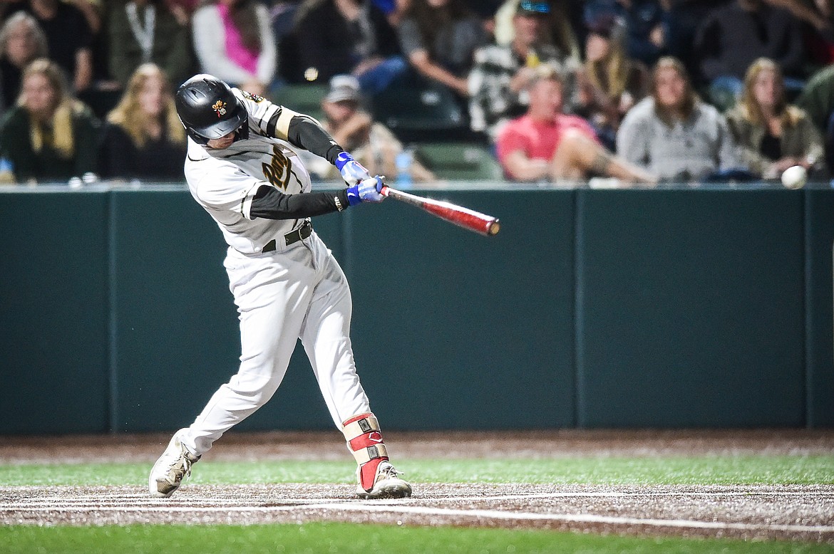 Glacier's Christian Kirtley (12) connects on a single in the sixth inning against Idaho Falls at Glacier Bank Park on Wednesday, Sept. 6. (Casey Kreider/Daily Inter Lake)