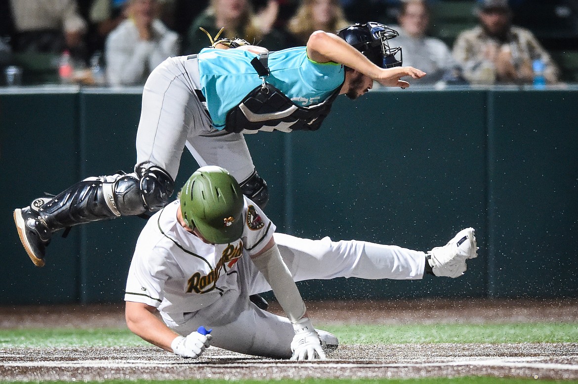 Glacier's Ben Huber (21) scores a run in the fifth inning after Mason Dinesen reached base on an error. (Casey Kreider/Daily Inter Lake)