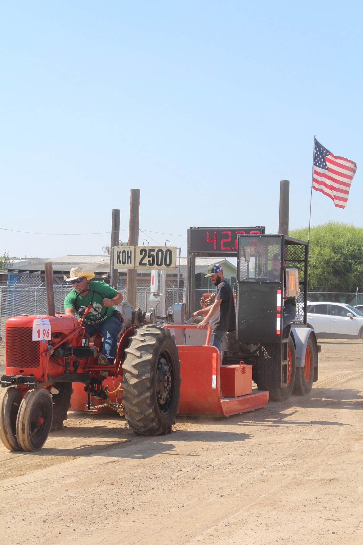 A tractor fights the sled in the tractor pull at Farmer Consumer Awareness Day 2022. The tractor pull returns in 2023.