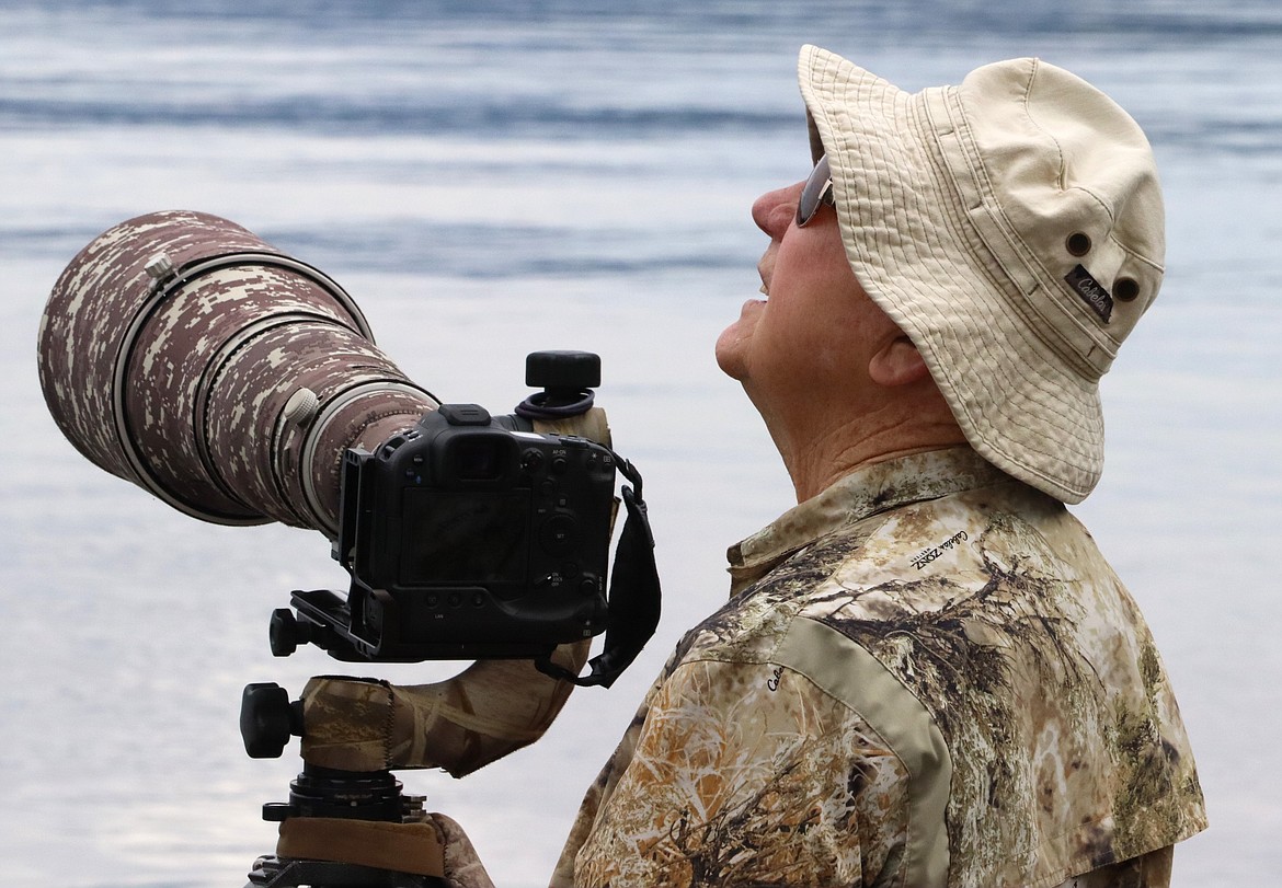 Larry Krumpelman of Post Falls watches for osprey at Hayden Lake on Wednesday.