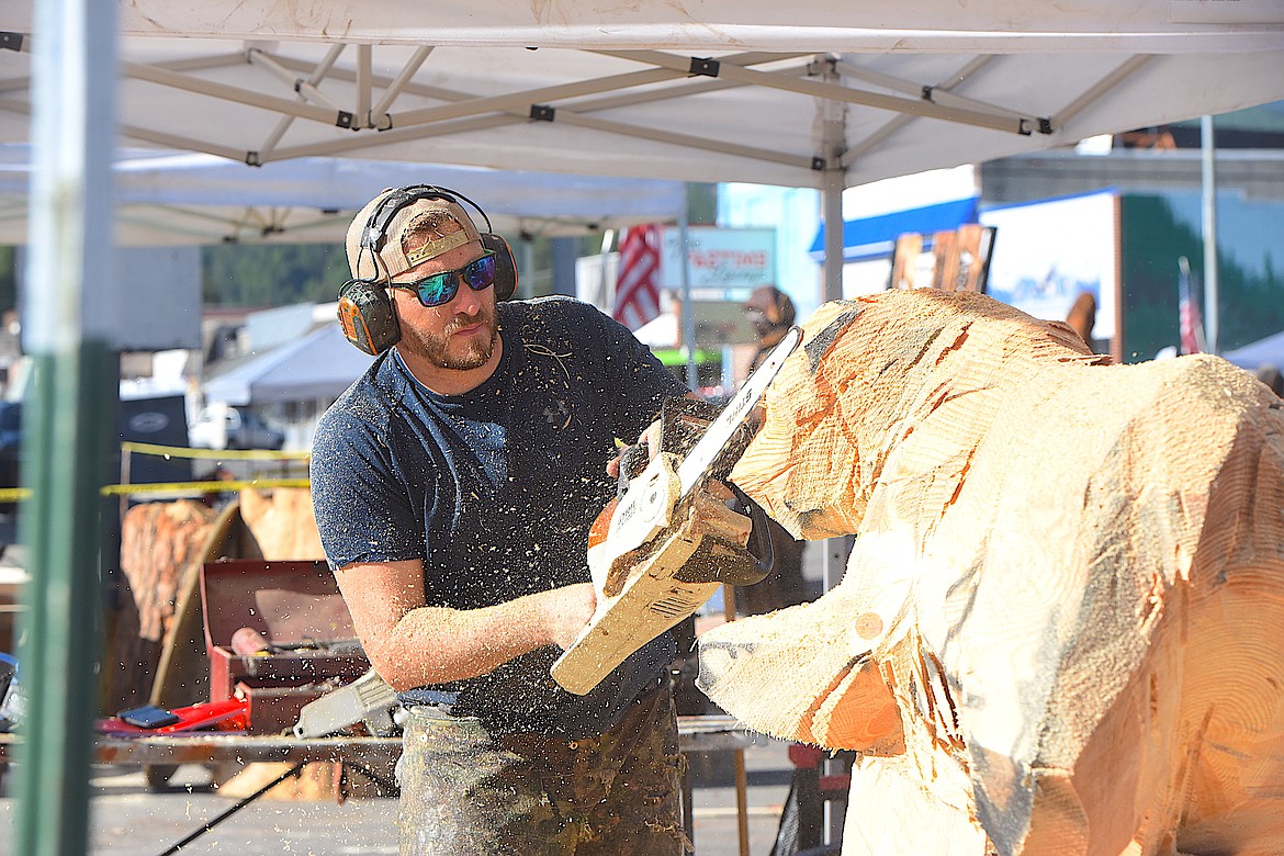 United States Jacob Lucas works on a piece of wood Thursday morning at the Kootenai Country Montana International Chainsaw Carving Championship on Mineral Avenue in Libby. (Hannah Chumley/The Western News)