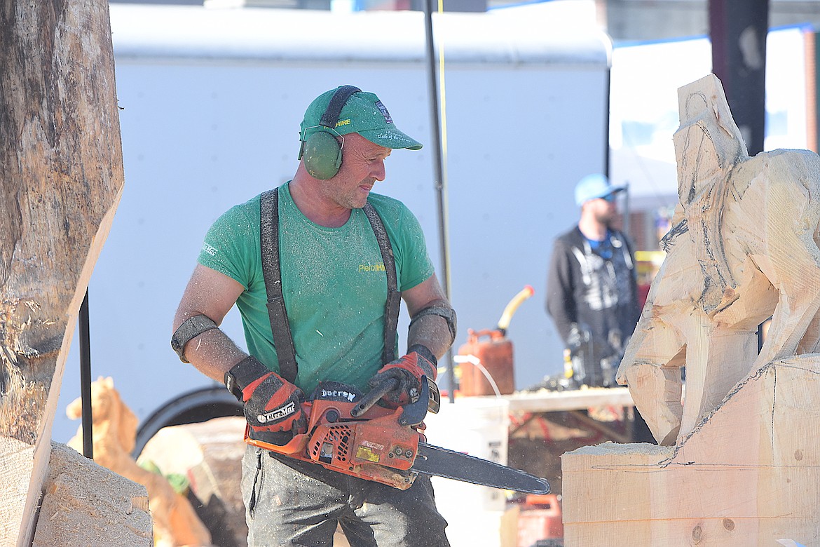 Ireland's John Hayes works on a piece of wood Thursday morning at the Kootenai Country Montana International Chainsaw Carving Championship on Mineral Avenue in Libby. (Hannah Chumley/The Western News)