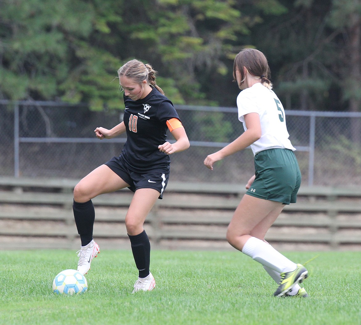 Priest River's Cheyenne Thompson turns with the ball, faking out a defender in a game earlier this season at Priest River Lamanna High School.