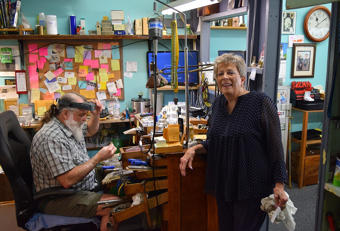 Nicholas Criscuolo, left, sits at his workbench working on a piece of jewelry next to his mother, Marty Utsunomiya, right, in the back room of Frederick’s Jewelry.