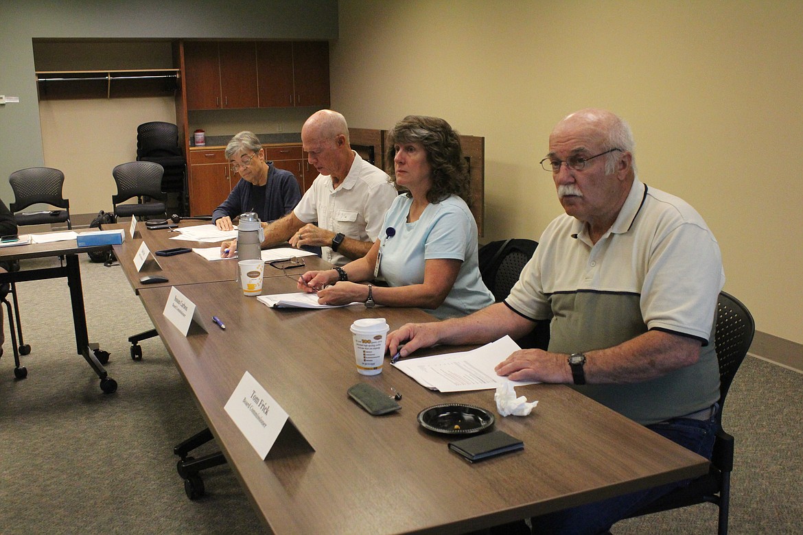 Samaritan Hospital commissioners, from left, Katherine Christian, Dale Paris, Susan Carbon and Tom Frick listen to a presentation on hospital financing Thursday.