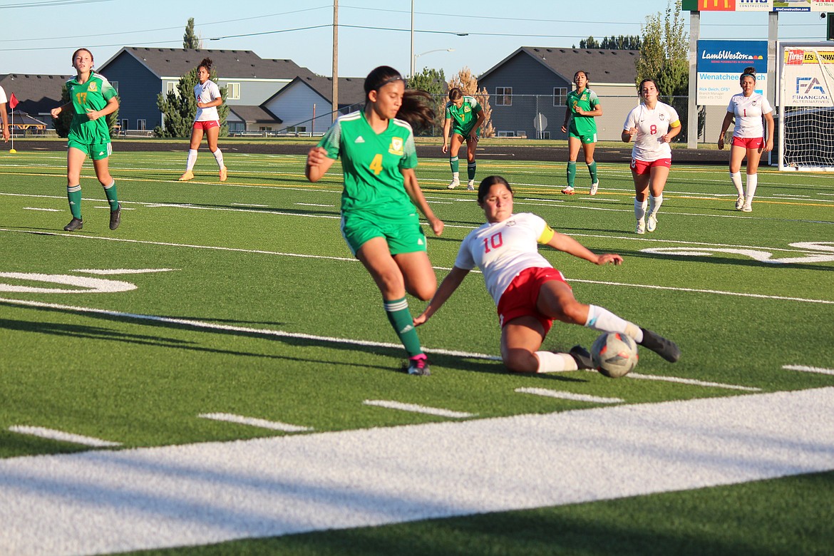 An Othello player hits the ground to kick the ball away from a Quincy player in the Huskies’ 2-1 win Tuesday.