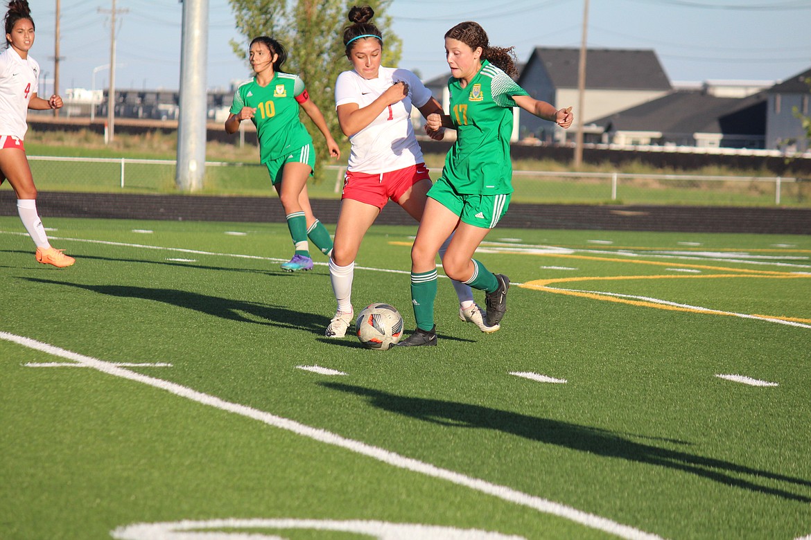 Quincy and Othello players fight for the ball during Othello’s 2-1 win over the Jacks Tuesday in Quincy.