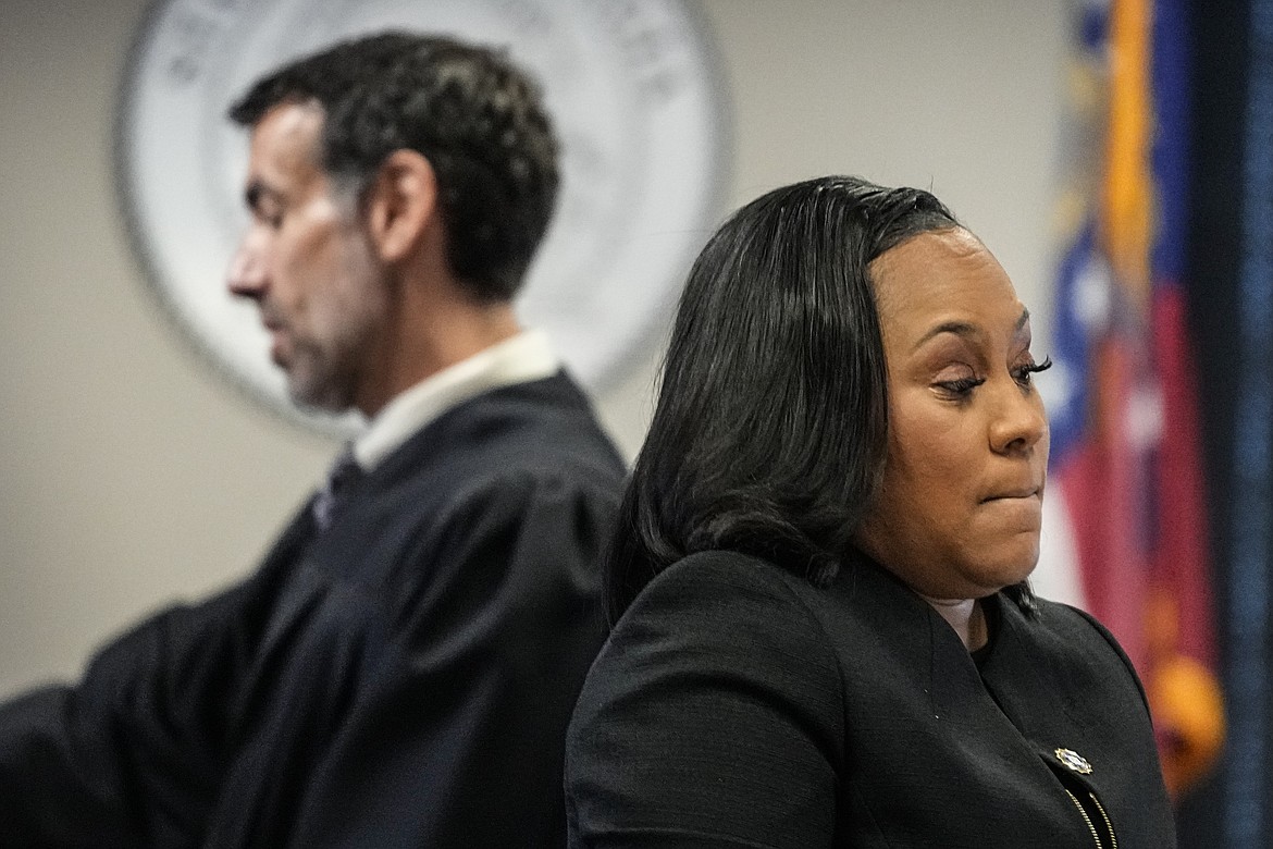 Fulton County District Attorney Fani Willis, right, and Fulton County Superior Court Judge Robert McBurney speak in the Fulton county courthouse, Tuesday, July 11, 2023, in Atlanta. A judge on Friday, Sept. 8, is expected to release the full report compiled by a special grand jury that helped an investigation by the Georgia prosecutor who ultimately indicted former President Donald Trump and 18 others. (AP Photo/Brynn Anderson, File)