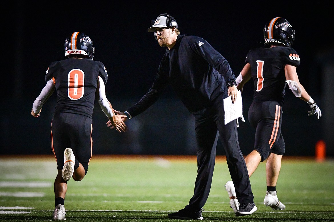 Flathead head coach Caleb Aland congratulates his offense after a score in the third quarter against Missoula Big Sky at Legends Stadium on Friday, Sept. 8. (Casey Kreider/Daily Inter Lake)