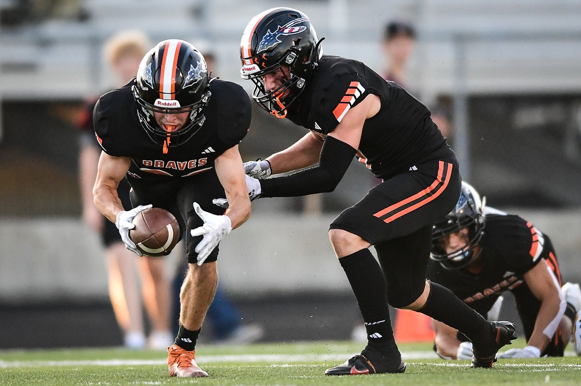 Flathead safety Brody Thornsberry (88) scoops up a fumble with fellow defender Stephen Riley (7) in the first half against Missoula Big Sky at Legends Stadium on Friday, Sept. 8. (Casey Kreider/Daily Inter Lake)