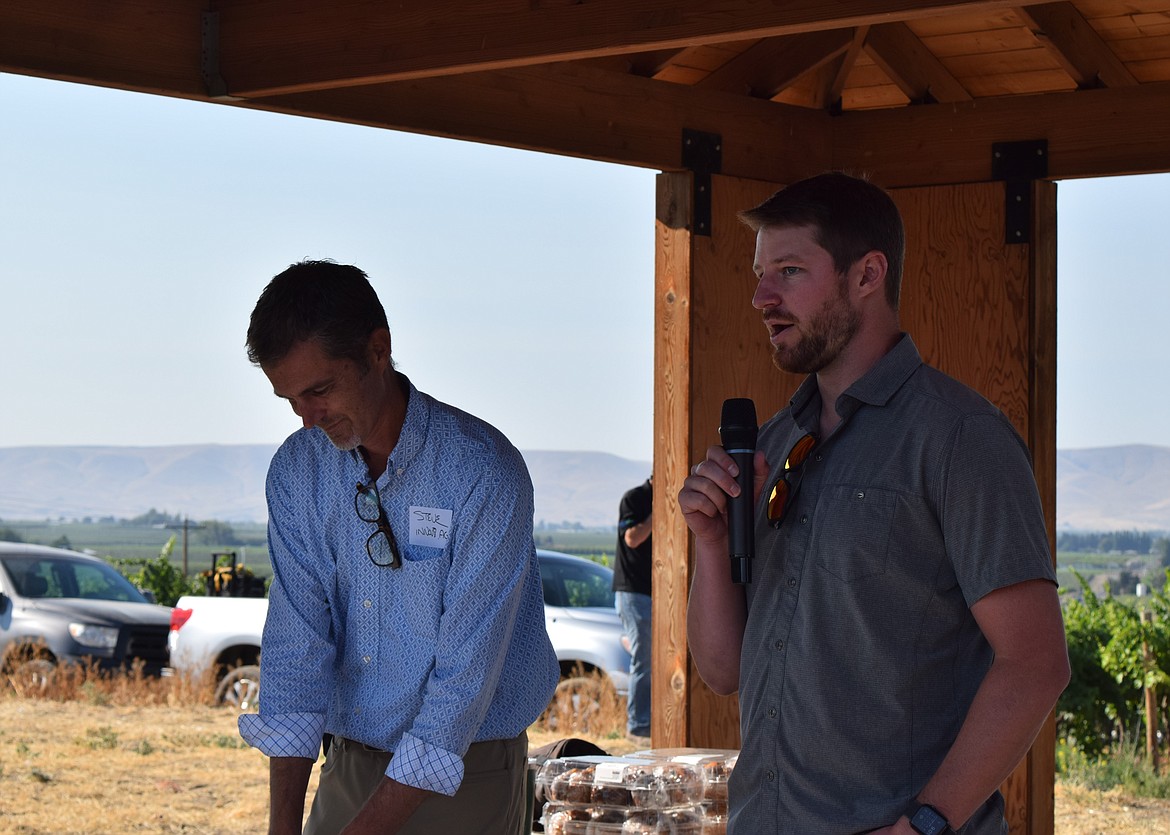 The head of the Washington Fruit Growers company, Gilbert Plath, right, speaks during the Smart Orchard Field Day introduction. Steve Mantle, the founder of innov8.ag, stands to Plath’s left.