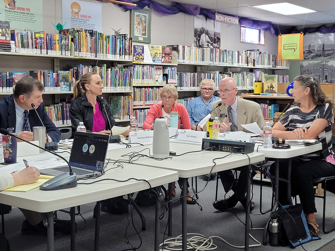 Vice Chair Tom Hanley speaks into the microphone Friday morning during a meeting of the Community Library Network's board of trustees at the Harrison Library. From left: Tim Plass, Vanessa Robinson, Katie Blank, Lindsey Miller-Escarfuller, Hanley and Rachelle Ottosen.