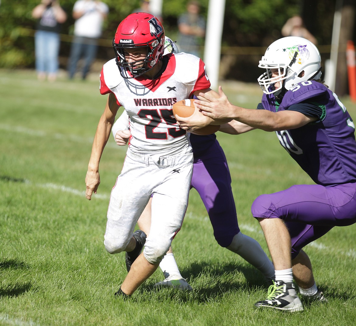 JASON ELLIOTT/Press
Kootenai junior wide receiver Simon Hodges breaks the tackle of Mullan-St. Regis senior defensive lineman Seth Hess for a first down during Friday's North Star League game at John Drager Field in Mullan.