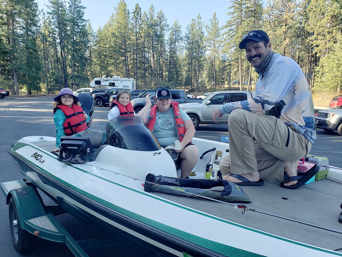 From left, Quinn, Riley and Kate Gothner settle into Cameron Bandy's boat for a day of fishing near Q'emiln Park on Sunday.