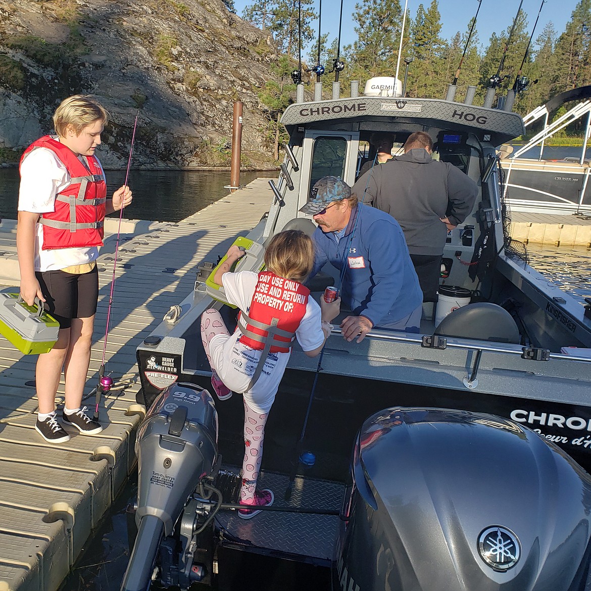 Arianna Nash, 15, watches her sister Sophia, 8, climb aboard a brand new boat for a day of fishing with C.A.S.T. for Kids volunteers. The nonprofit organizes annual fishing trips to get kids with special needs or disabilities on the water.