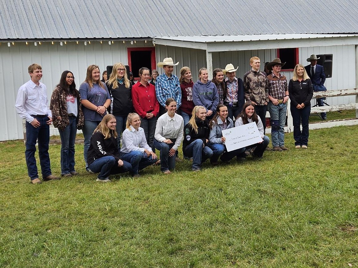 Cyndi Champion, far right, presents a check for $1,000 to Sanders County 4-H on behalf of AgWest Farm Credit at the awards ceremony as this year's fair came to an end. (Lisa Larson/VP-MI)