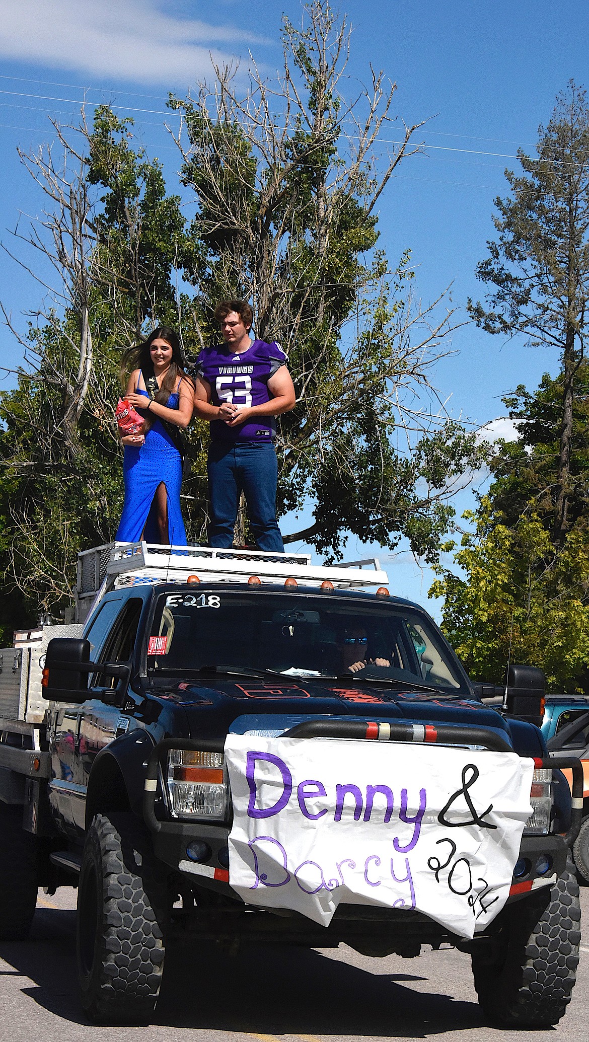 Charlo Homecoming queen candidate Darcy Coleman and king candidate Denny Black rode atop a fire truck as they wend their way through Charlo during Friday's parade. (Berl Tiskus/Leader)