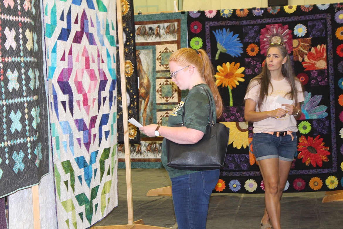 Quilt show attendees check out the entries in the Farmer Consumer Awareness Day quilt show Saturday.