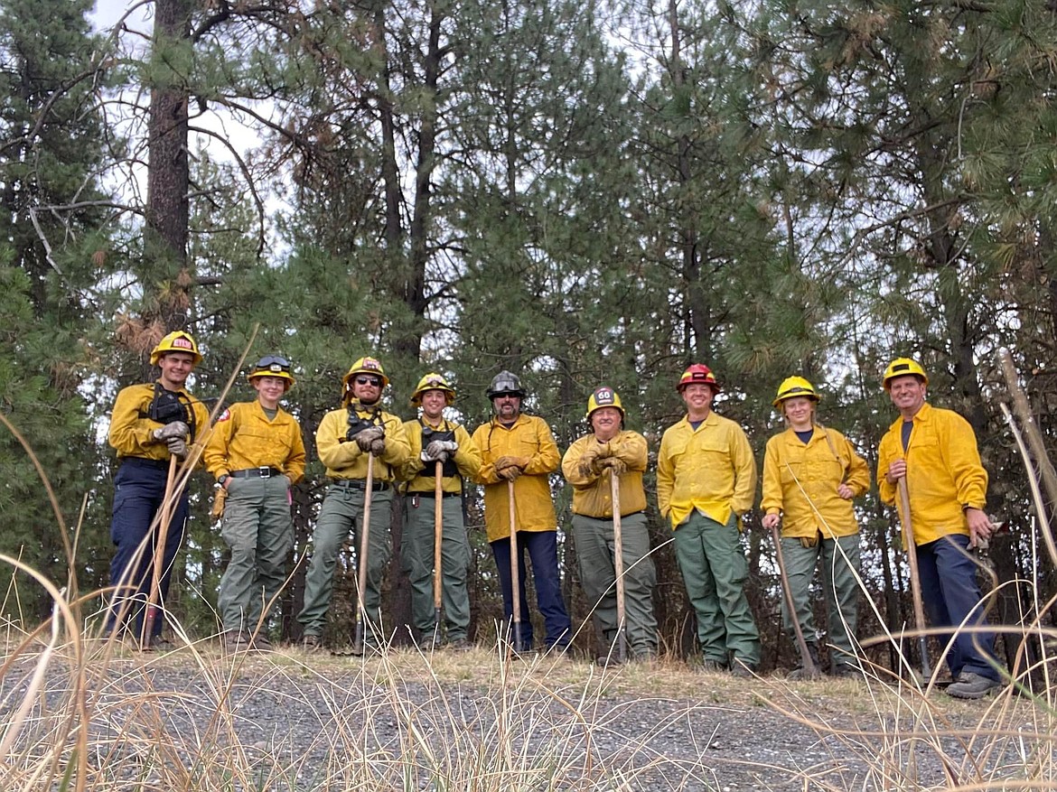 The strike team that included Moses Lake firefighters Nigel McNeill and Doug Presta takes a break from rehabbing a handline at the Gray fire west of Spokane to pose for a photo. McNeill wasn’t sure of the names of some of the other personnel, but he’s fifth from the left and Presta is at the far right.