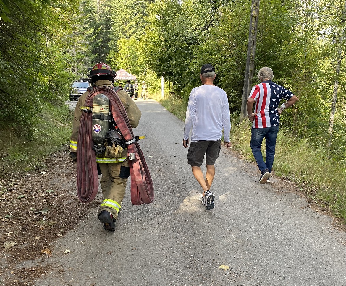 Victor Malsom (left) and Timothy Fennell walk to the descent to begin another lap in the stair climb. Malsom carried with him a fire hose to add weight to honor the fallen firefighters on Sept. 11 2001.